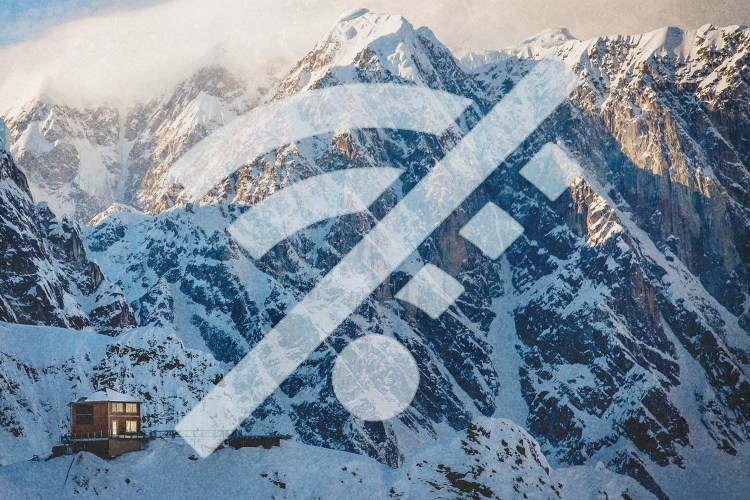 A wi-fi symbol crossed out in front of a mountain range