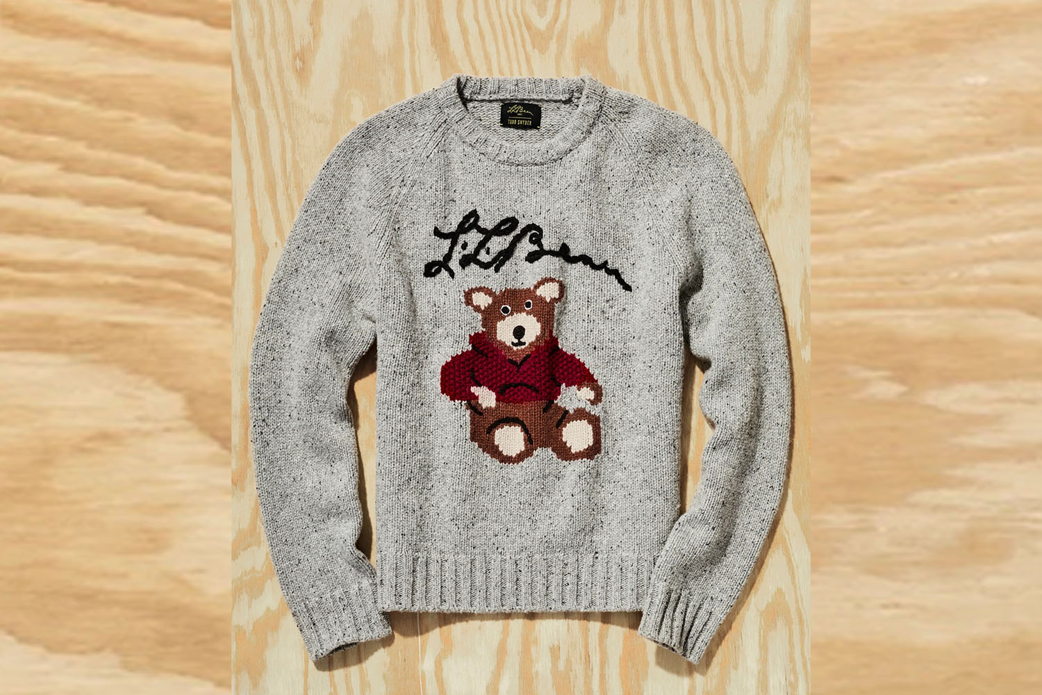 a Todd Snyder x L.L. Bean Sweater on a wooden background