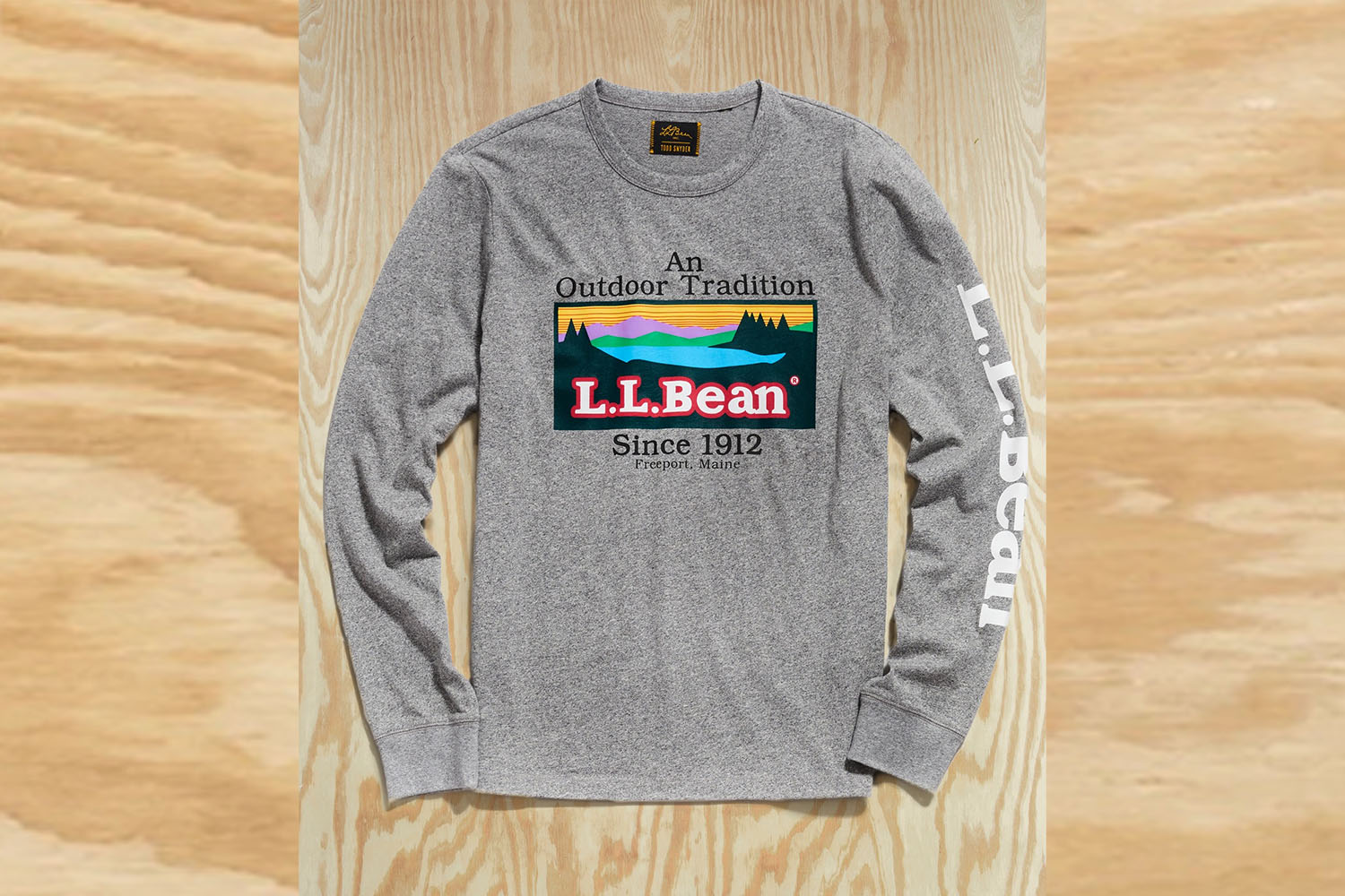 a Todd Snyder x L.L. Bean Tee on a wooden background