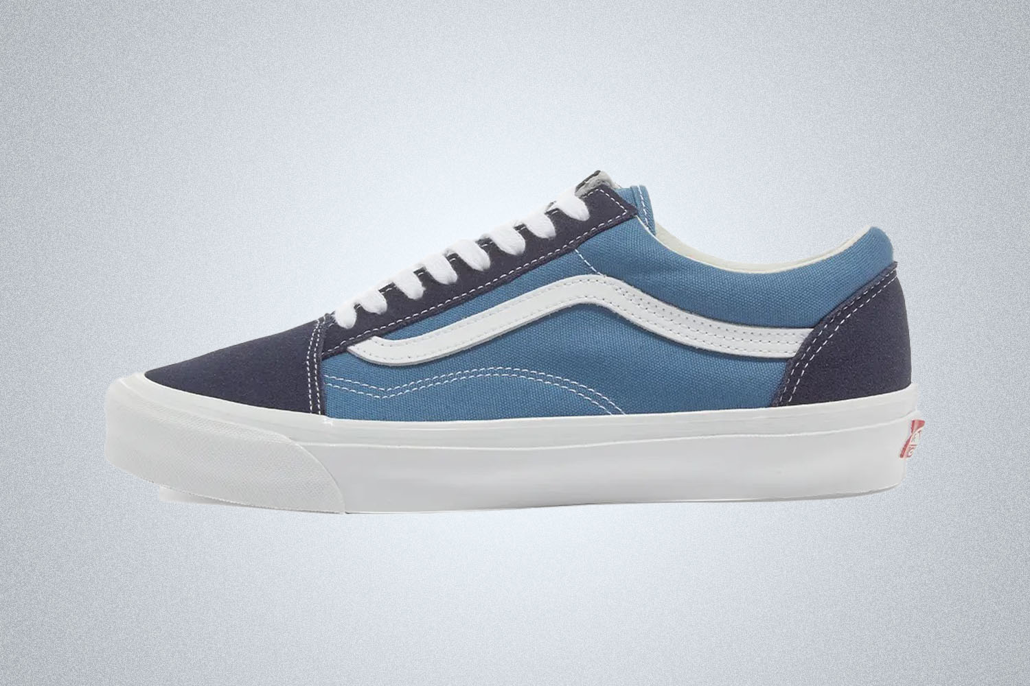 a pair of light blue and dark blue vans from End. Clothing on a grey background