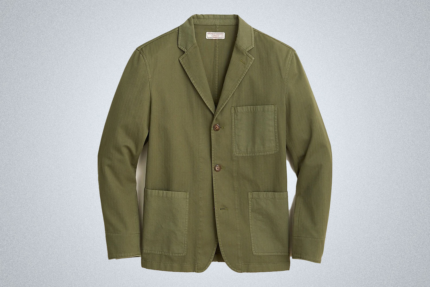 a green blazer from Wallace and Barnes on a grey background