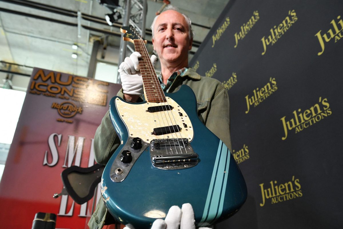 The blue 1969 Mustang Fender guitar used by Kurt Cobain is displayed by Julien's Auctions CFO Martin Nolan