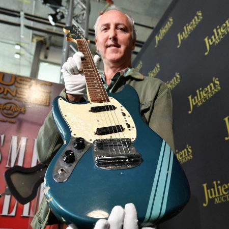 The blue 1969 Mustang Fender guitar used by Kurt Cobain is displayed by Julien's Auctions CFO Martin Nolan