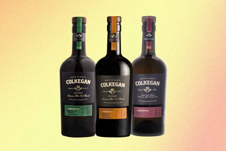 three bottles of various Colkegan single malts, a smoky whiskey from New Mexico
