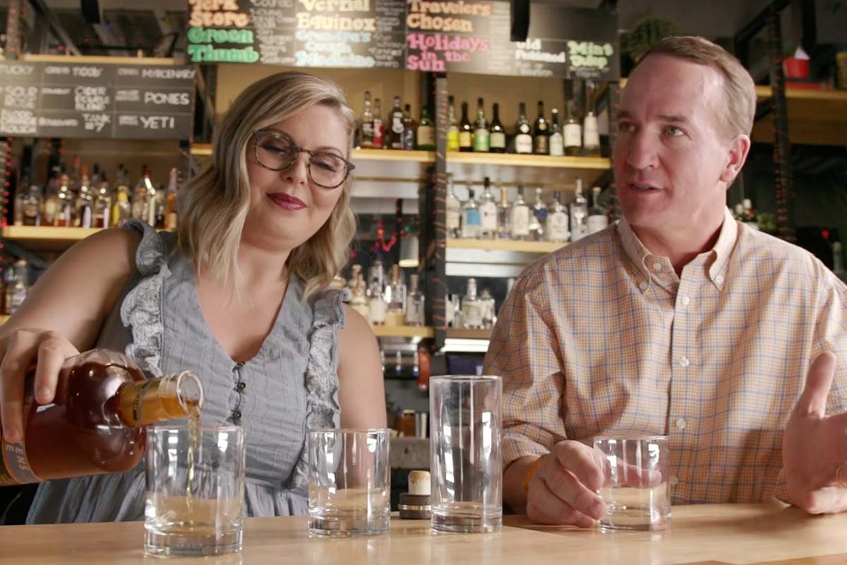 Marianne Eaves and Peyton Manning of Sweetens Cove drinking whiskey at a bar