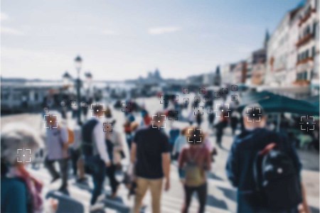 Face recognition signs and tags on people faces. Privacy and personal data protection. Blurred picture with drawn symbols.