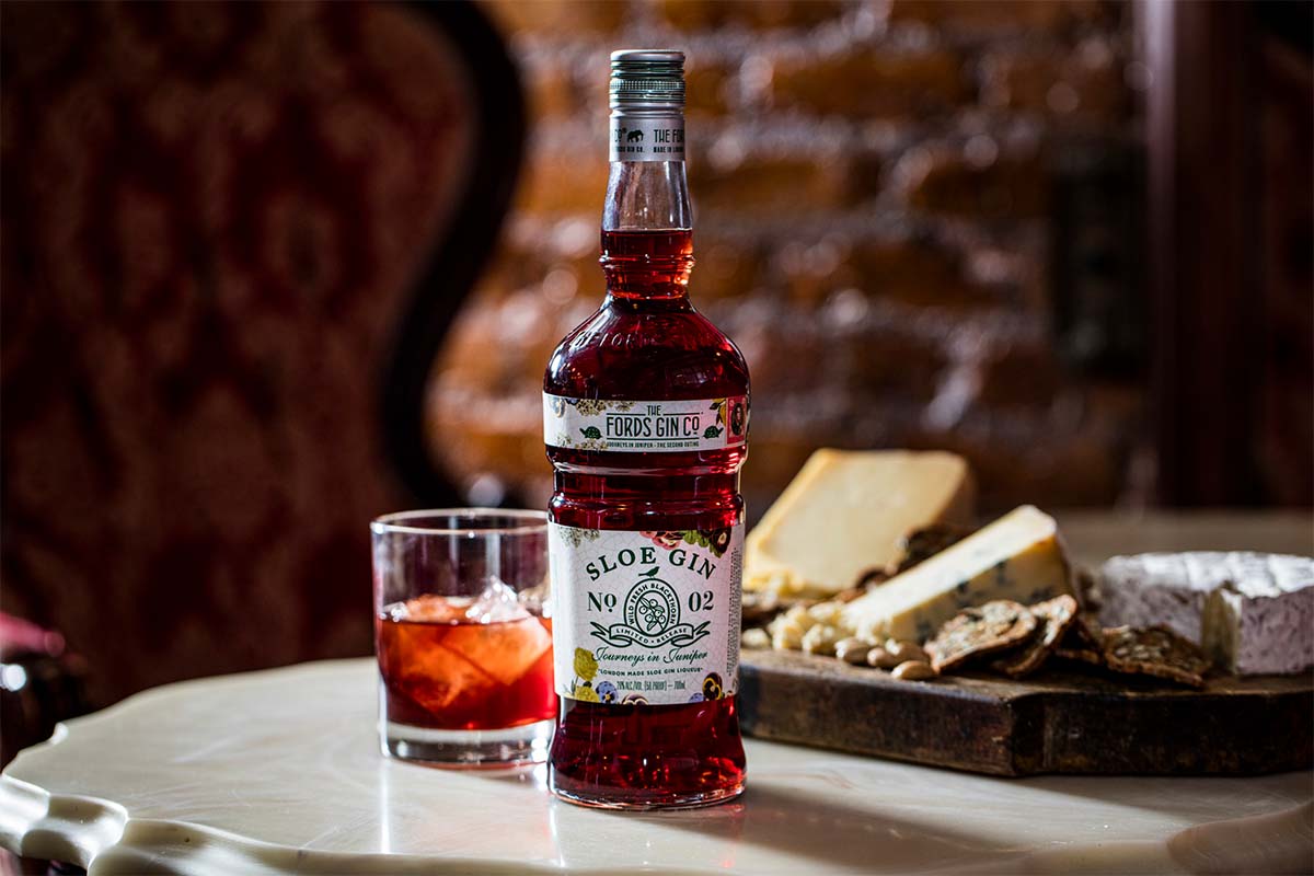 Fords Sloe Gin, a cocktail and a cheese board on a table. Fords Sloe Gin is a new release and an updated take on a classic UK liqueur.