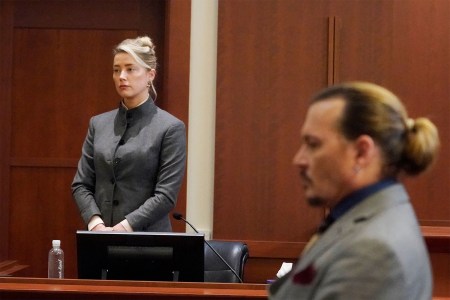Amber Heard (L) and Johnny Depp watch as the jury leaves the courtroom at the end of the day at the Fairfax County Circuit Courthouse in Fairfax, Virginia, May 16, 2022.