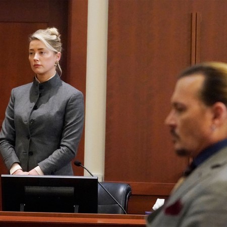 Amber Heard (L) and Johnny Depp watch as the jury leaves the courtroom at the end of the day at the Fairfax County Circuit Courthouse in Fairfax, Virginia, May 16, 2022.
