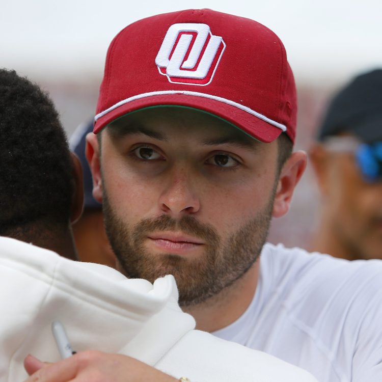 Ex-Oklahoma Sooners quarterback Baker Mayfield greets a former player