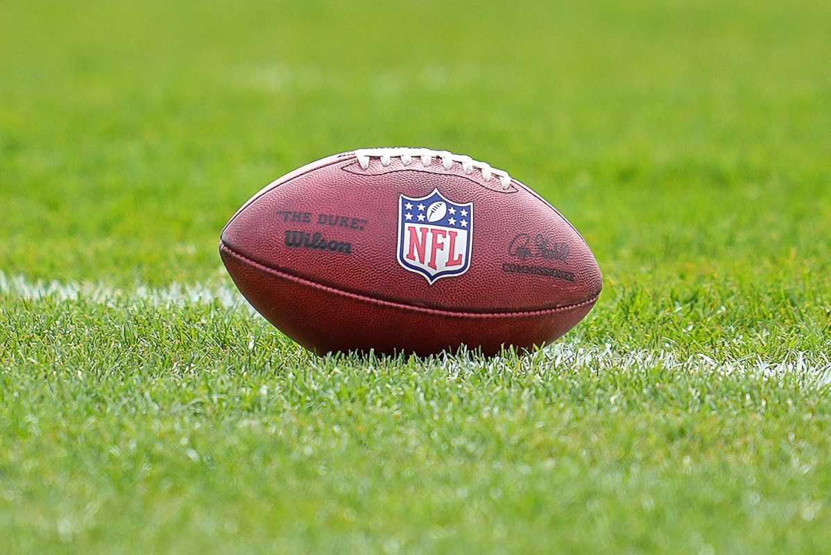 The NFL logo crest is seen on a football during rookie minicamp in May