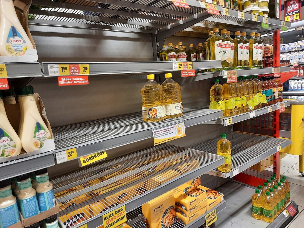 A grocery store shelf with a few bottles of cooking oil. Sunflower oil shortages are happening around the world because of the war in Ukraine.