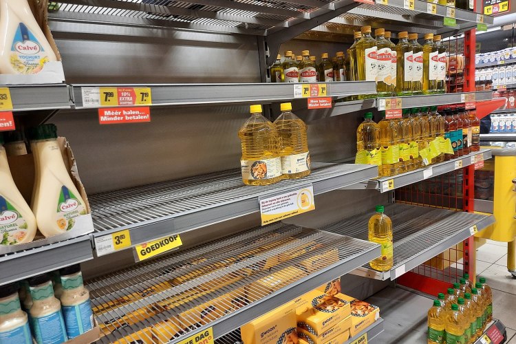 A grocery store shelf with a few bottles of cooking oil. Sunflower oil shortages are happening around the world because of the war in Ukraine.