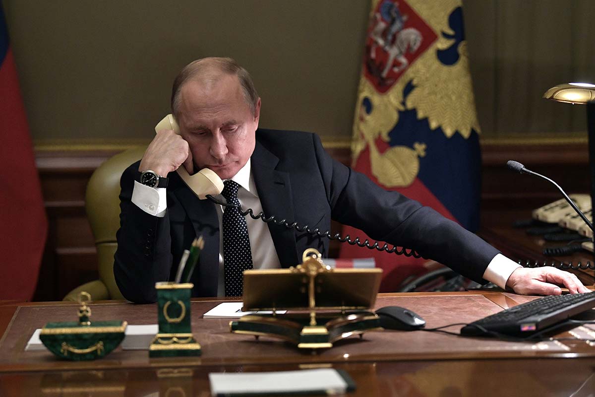 Russian President Vladimir Putin speaks on the phone in his office in Saint Petersburg on December 15, 2018