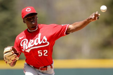 Starting pitcher Reiver Sanmartin of the Reds throws against the Colorado Rockies