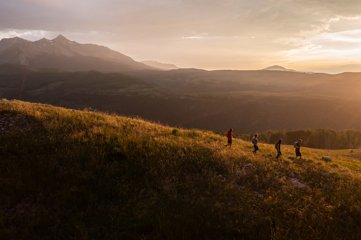 Four people hiking as part of the Reset trekking retreat in Telluride, Colorado, which just launched in May 2022