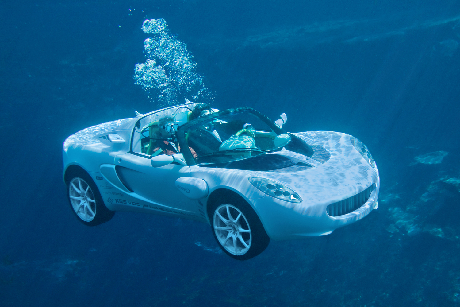 The sQuba aquatic car from Rinspeed, shown here with the passengers wearing scuba gear and the car underwater