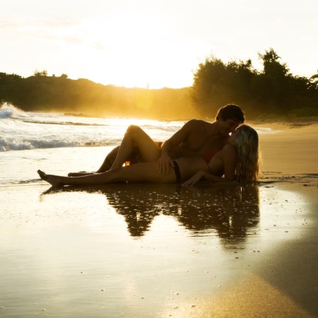 Couple canoodling on the beach at sunset. If you think this is what Sex Island, the straight male fantasy event that's returning in May 2022, looks like, you're wrong. It's in Las Vegas.