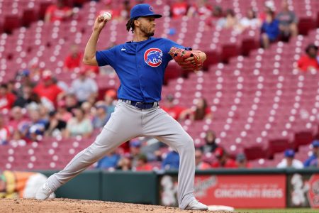 Shortstop Andrelton Simmons of the Chicago Cubs pitches against the Cincinnati Reds