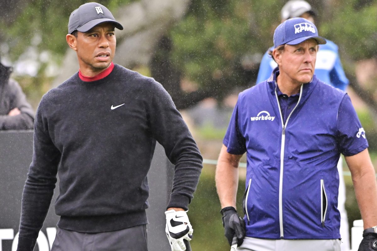Tiger Woods watches his tee shot while Phil Mickelson gets ready to hit at the ZOZO Championship in 2020