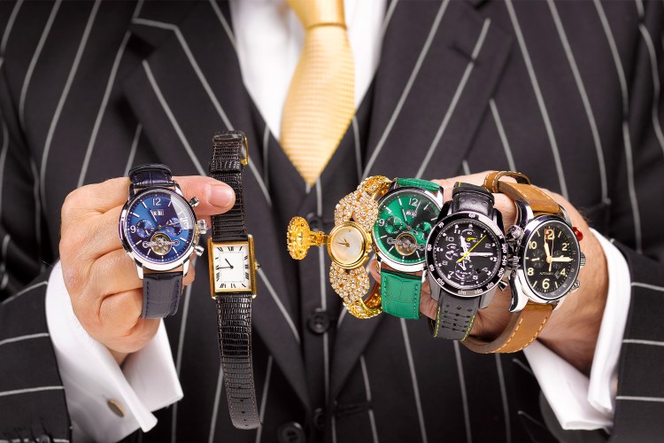 Man holding multiple watches