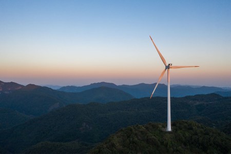A wind turbine on a hill.