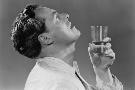 A man gargling water in an old advertisement.