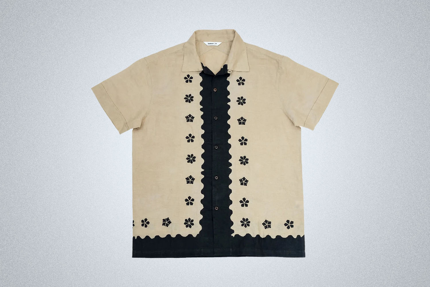 a biege shirt with black detailing from 3sixteen on a grey background