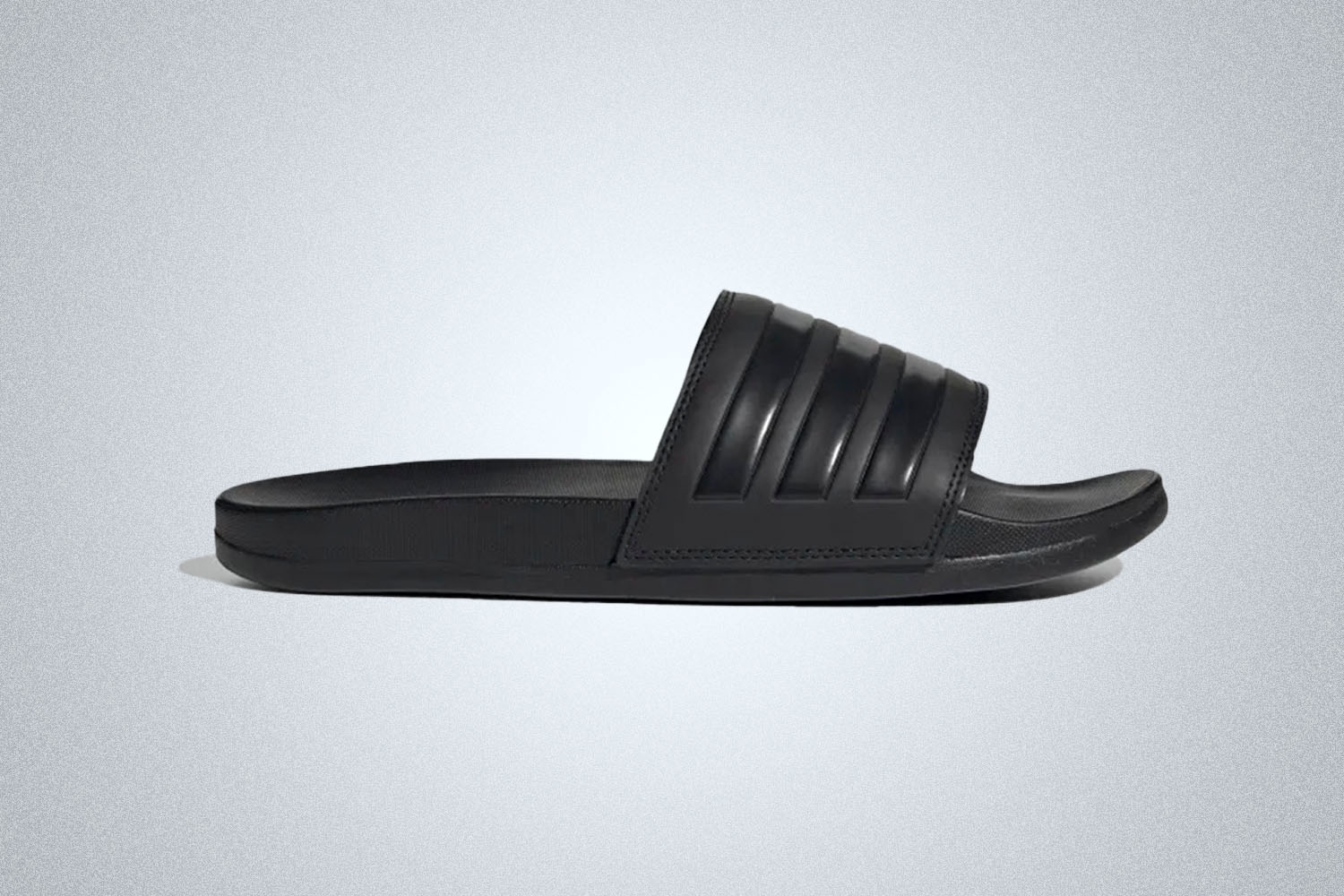 a pair of black adilette slides from Adidas on a grey background