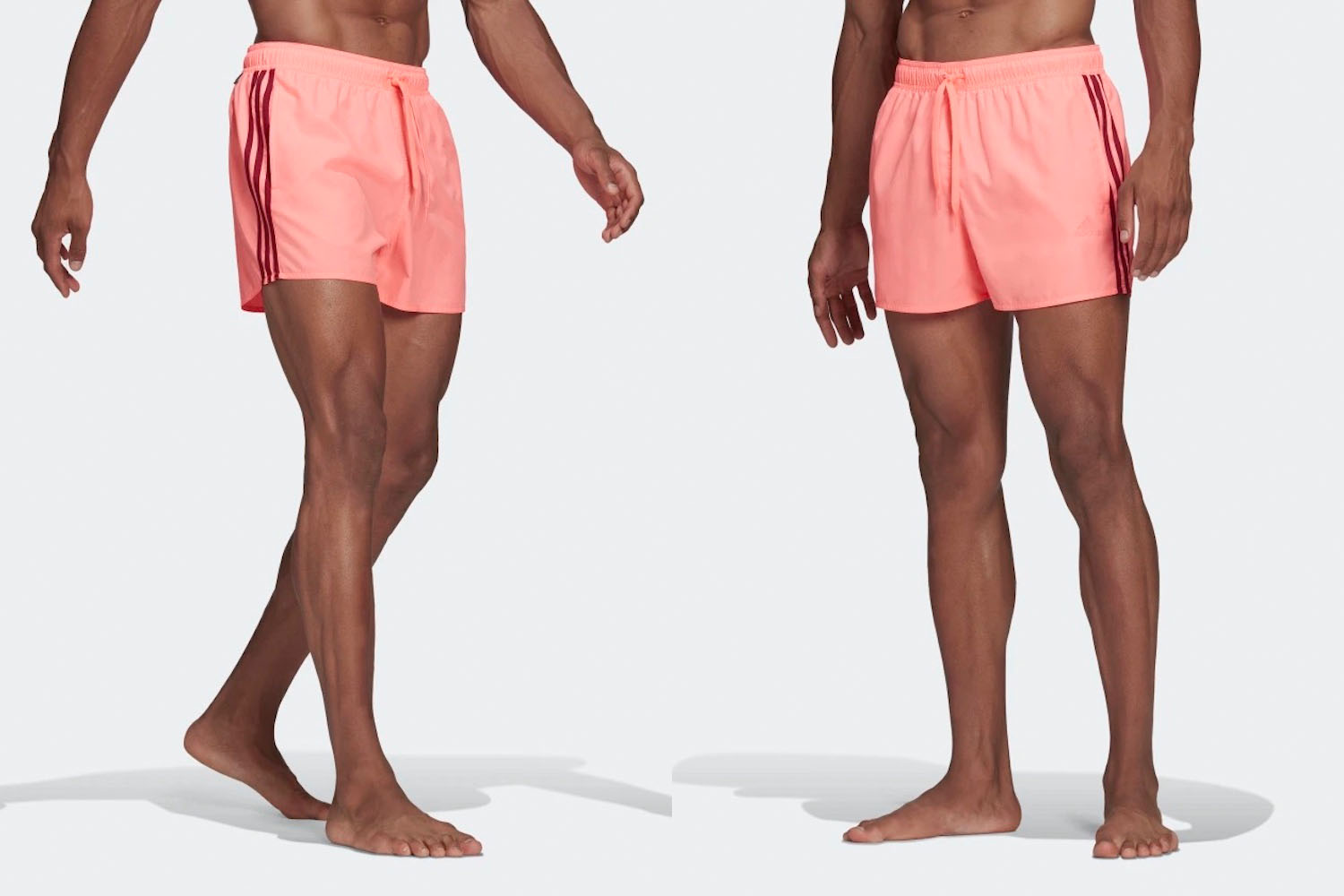 two on-model shorts of a pink adidas short swimsuit