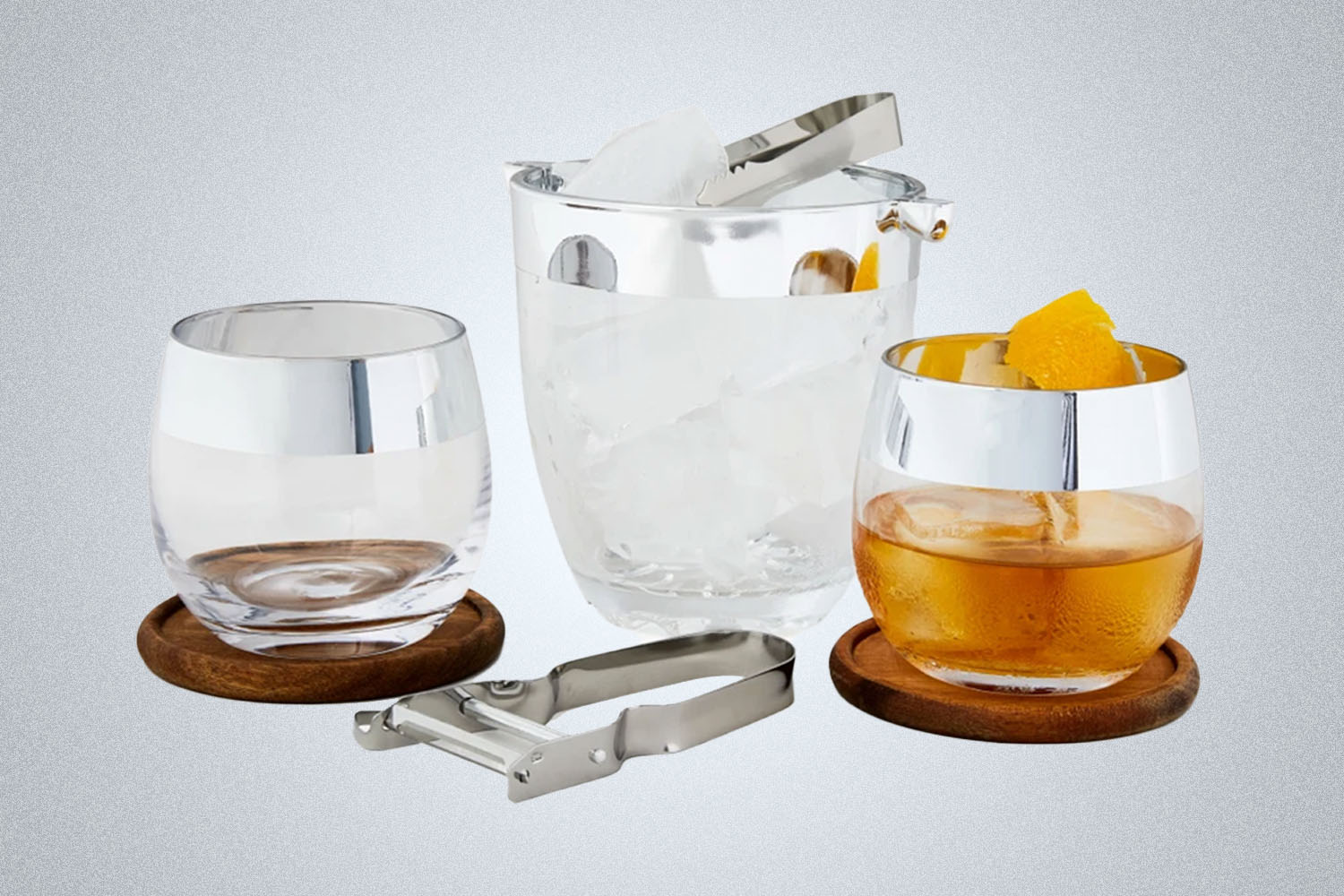 a collection of bar items  from Bespoke Post on a grey background