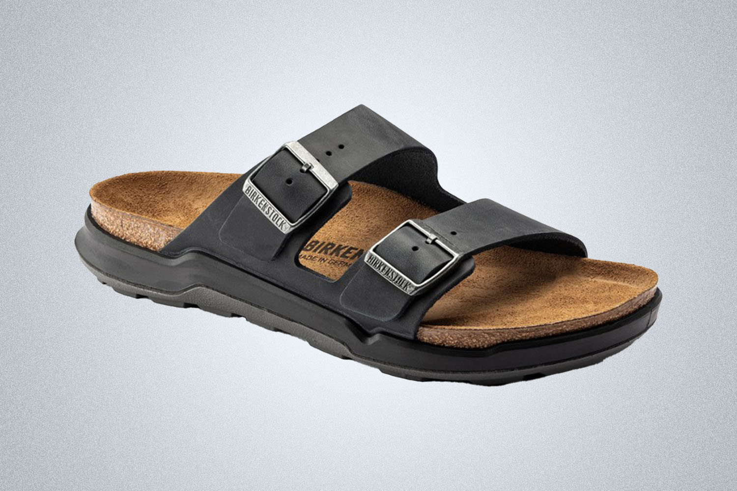 a pair of black Birkenstock Arizona Rugged Sandals on a grey background