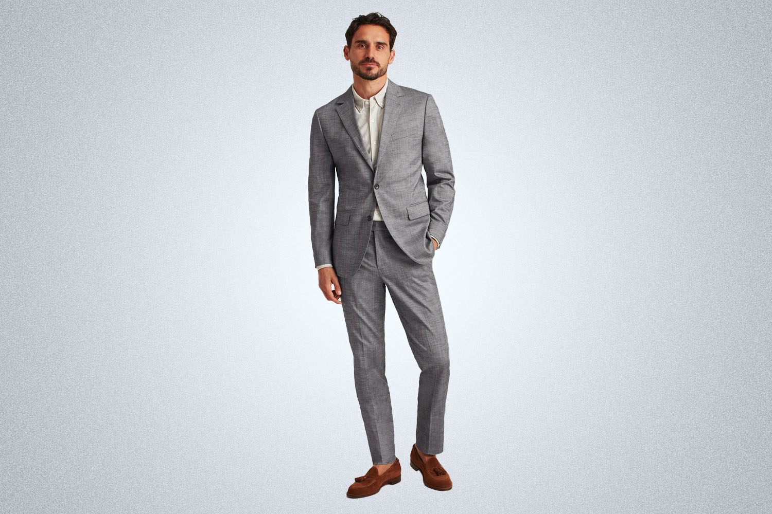 a model in a grey bonobos chambray summer suit on a grey background