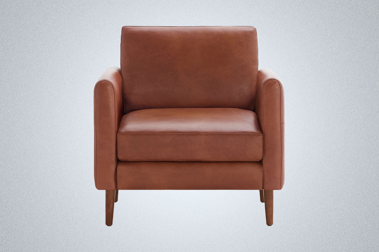a square leather armchair from Burrow on a grey background