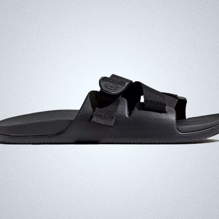 a pair of black Chaco Chillos Slides on a gray background