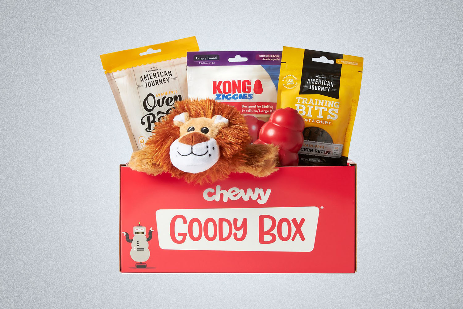 a red Chewy goody box of dog toys and treats on a grey background