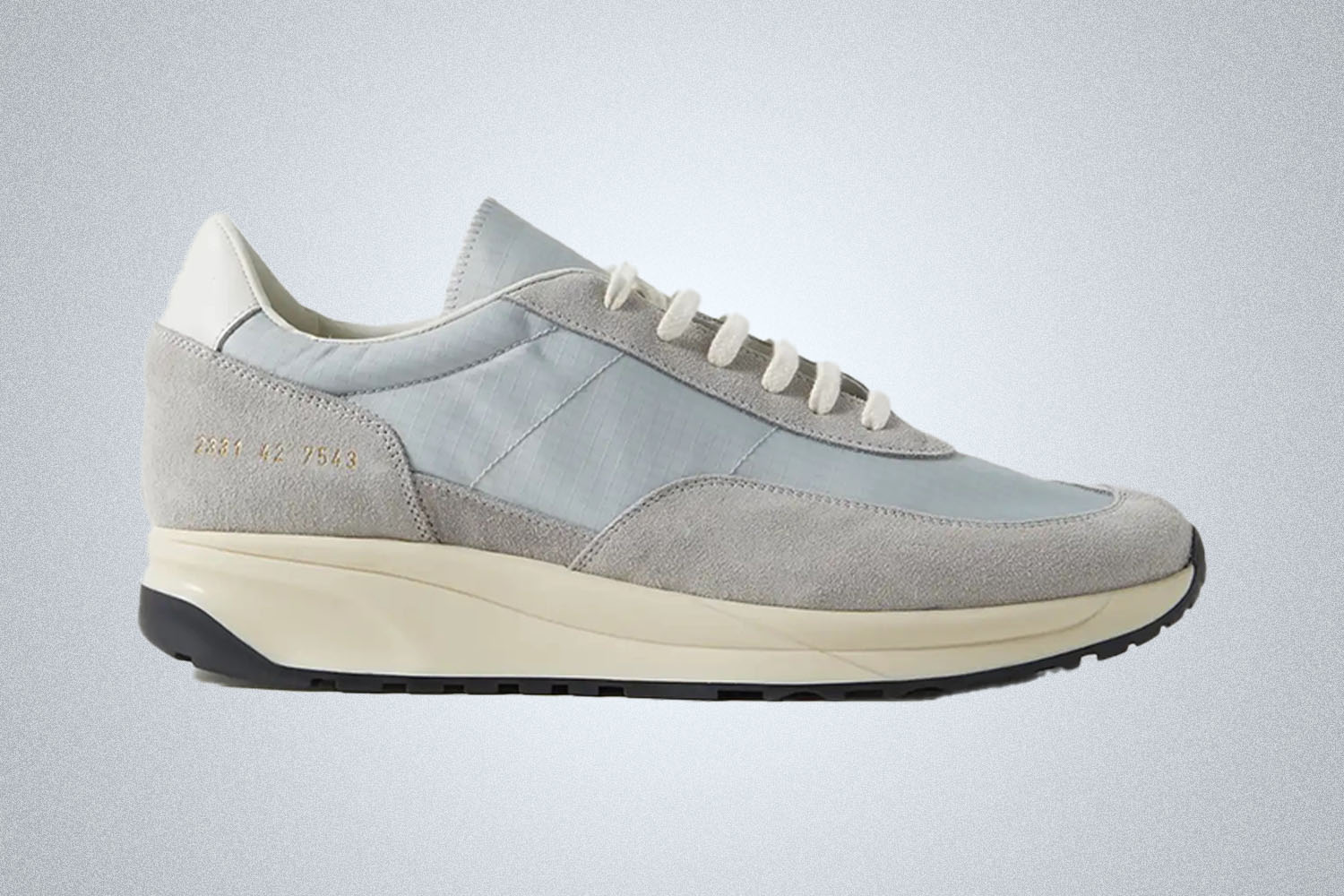 A grey retro running shoe by Common Projects from Mr. Porter on a grey background