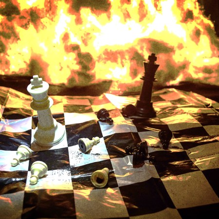 Chess pieces on a burning chess board