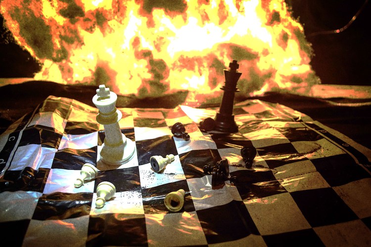 Chess pieces on a burning chess board