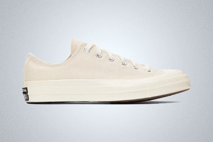 a white pair of Converse Chuck 70 on a grey background