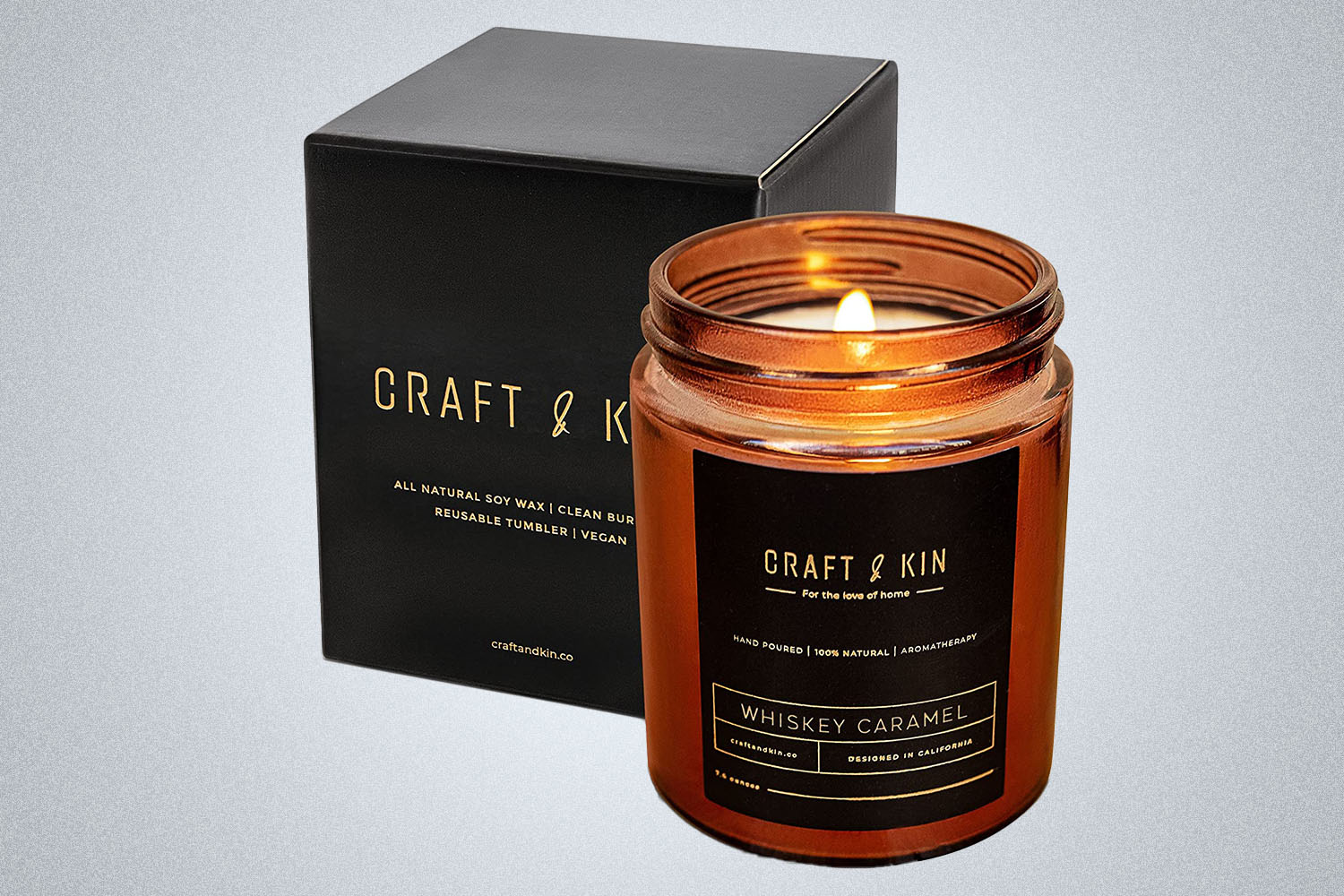 a Craft and Kin Whiskey-scented candle on a grey background