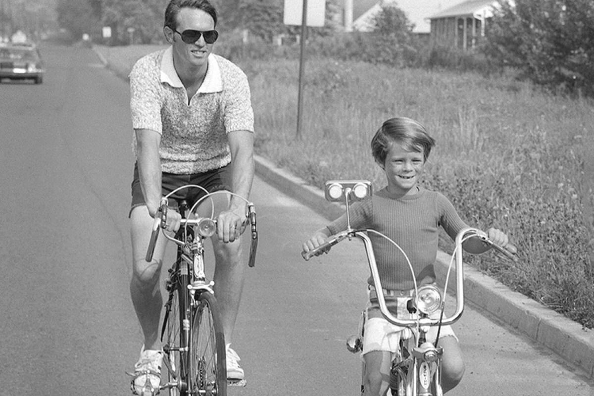 A man riding bikes with his son.