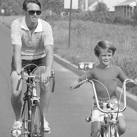 A man riding bikes with his son.