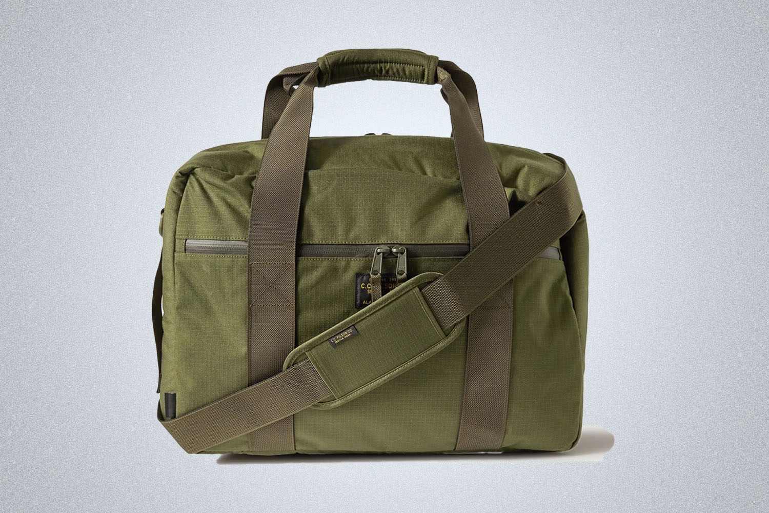 a green cordura Filson briefcase from Mr. Porter on a grey background