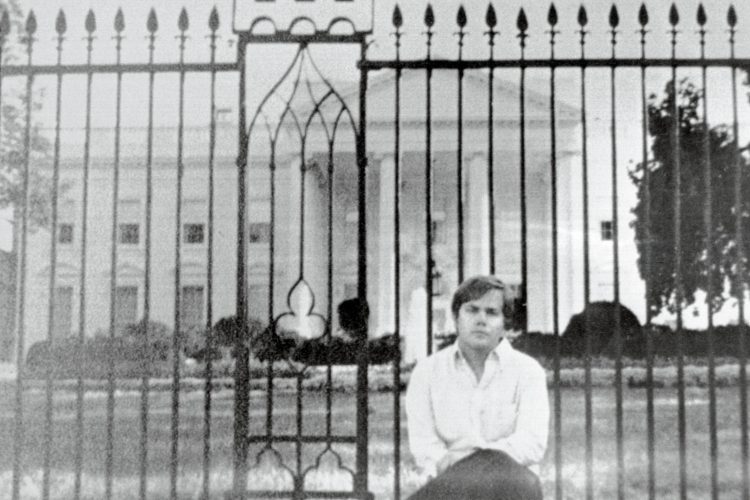 John Hinckley Jr. sits in front of the White House shortly before his 1981 attempted assassination of Ronald Reagan.