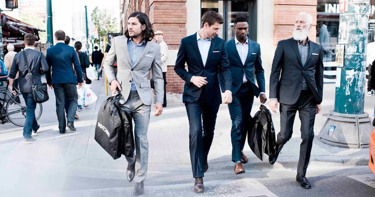 A group of men in Indochino suits walking down the street