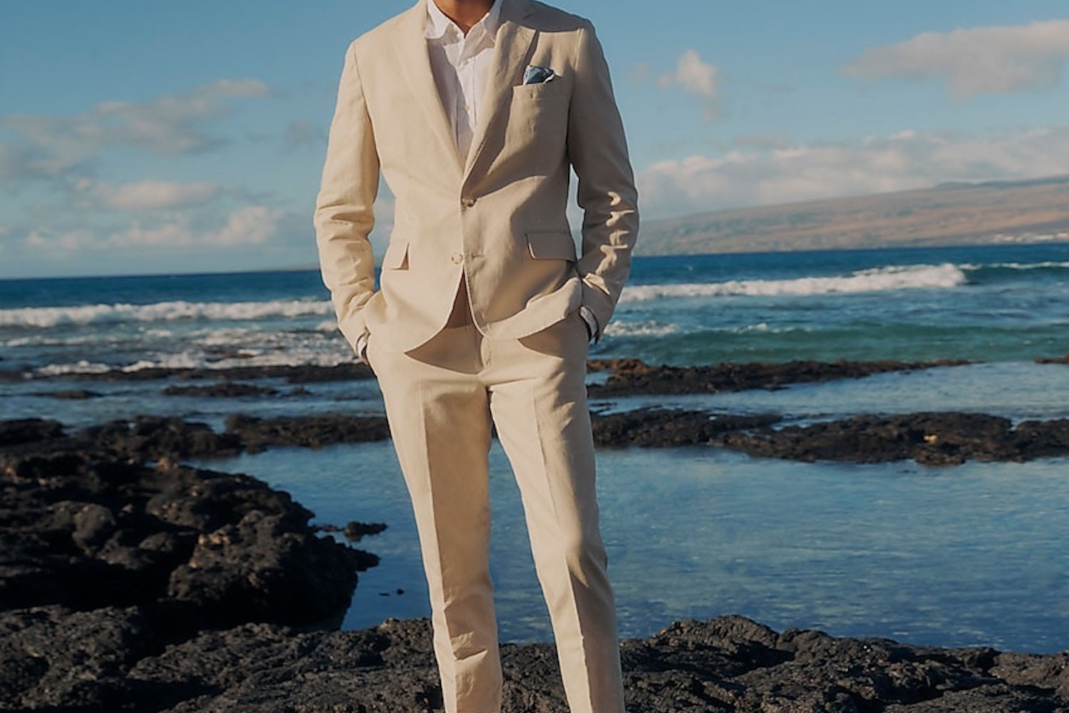 a model in a cream J.Crew linen suit against the ocean