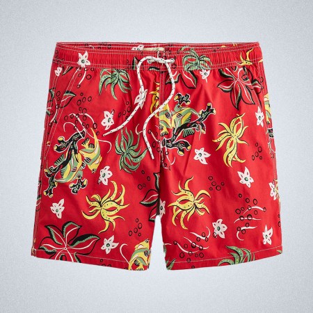 a pair of 8" red swim trunks with mulit-colored flowers printed on from J.Crew on a grey background