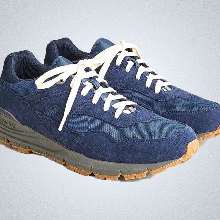 a pair of blue trail running shoes with gumsoles from J.Crew on a grey background