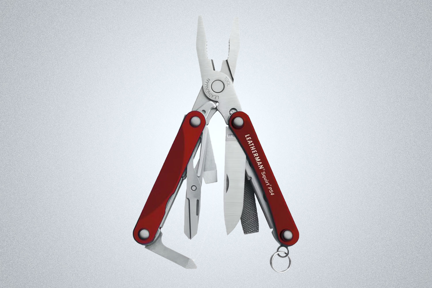 a red leatherman mulit-tool on a grey background